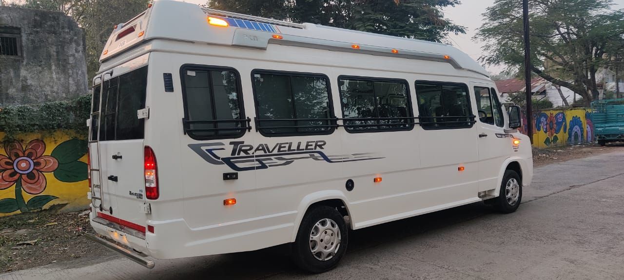 White 12-seater Force Traveller from the Dhruv Travels fleet